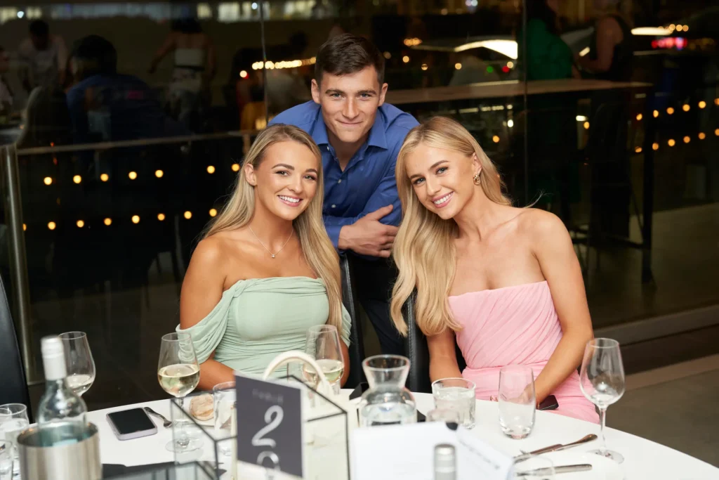 Guests smiling for a portrait at the Garryowen Awards Night in Melbourne, captured before the formal dinner began