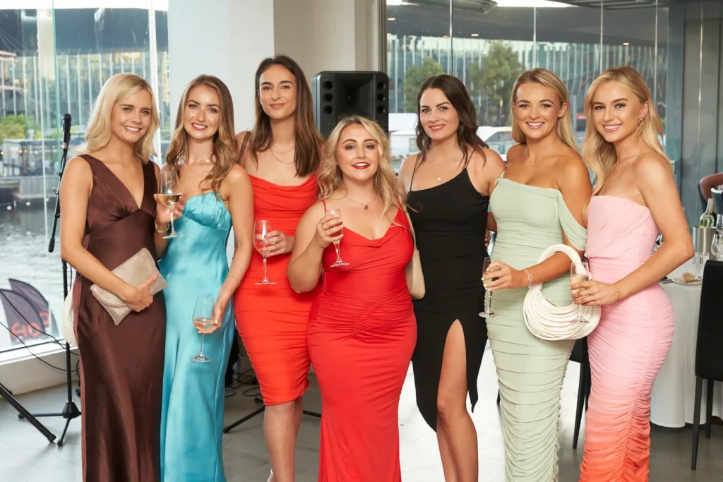 svg%3E Group of guests smiling with champagne at the Garryowen Awards Night, overlooking the Yarra River and Melbourne Exhibition Centre