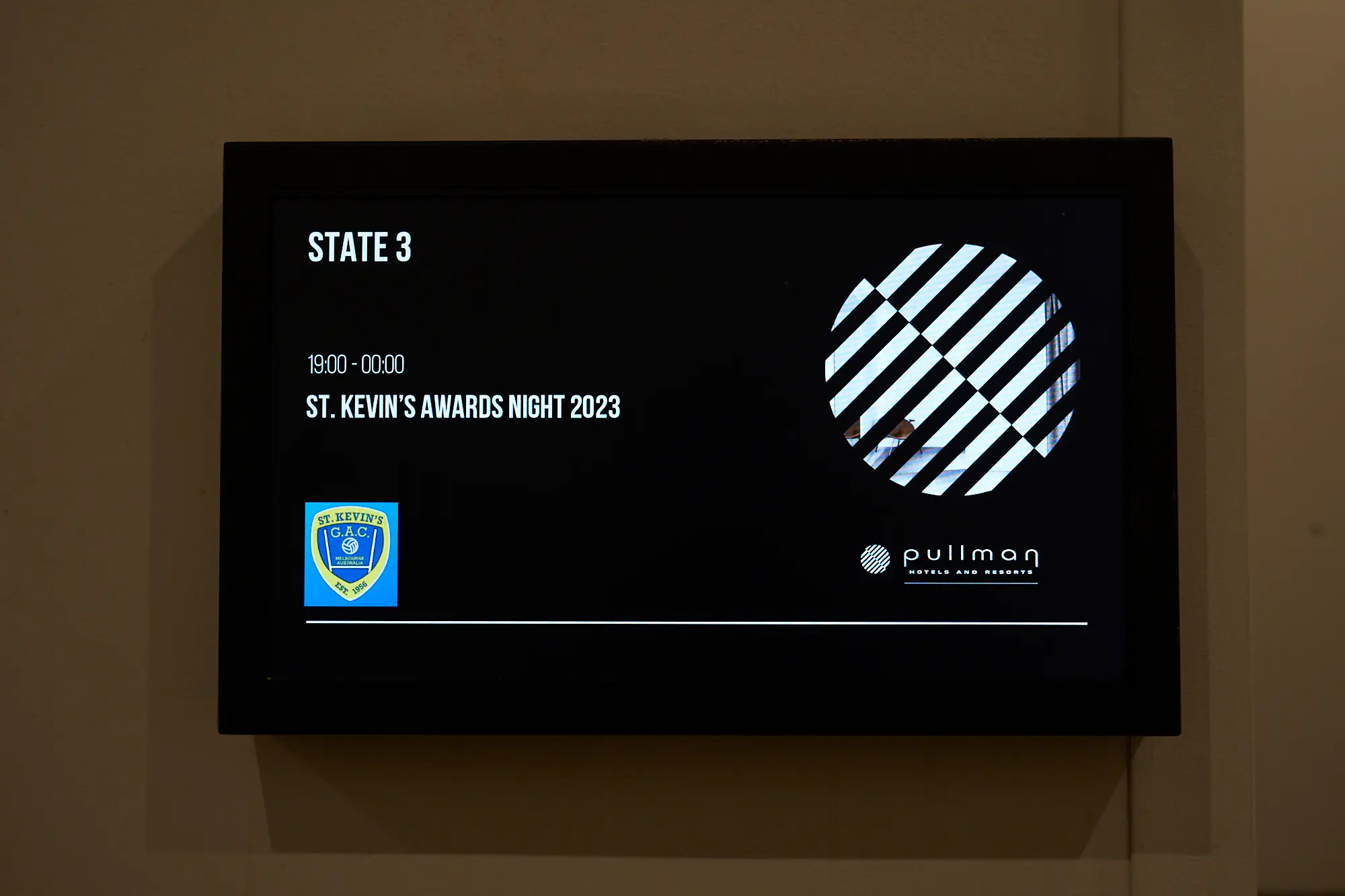 st kevins awards night pullman melbourne albert park digital display signage A digital display screen at the entrance of St. Kevin's Awards Night at Pullman Melbourne Albert Park shows event details with a sleek black background. The white text reads "ST. KEVIN'S AWARDS NIGHT 2023" along with the scheduled time "19:00–00:00". The display also features the St. Kevin’s GAC logo and the Pullman Hotels and Resorts logo, creating a professional and elegant welcome sign that sets the tone for the evening’s celebration.