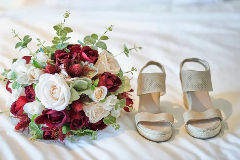 Close-up of bridal bouquet and shoe during bride getting ready