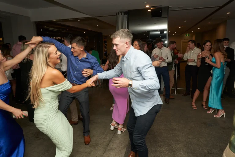 Two couples dancing in the foreground while an engaged crowd socializes and dances at the Garryowen Awards Night at River’s Edge Events, capturing the lively and joyful atmosphere